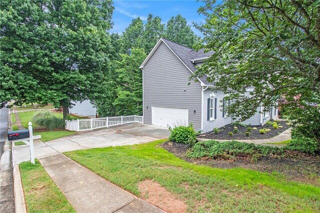 200 Ridge Bluff Ln, Suwanee, GA 30024 - view of side of property featuring a garage and concrete driveway