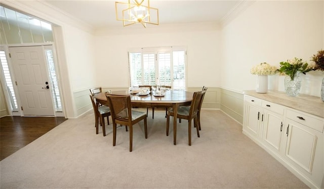 200 Ridge Bluff Ln, Suwanee, GA 30024 - dining room with light colored carpet, a chandelier, ornamental molding, wainscoting, and a decorative wall