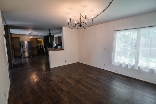 1530 Unity Church Cir, Maysville, GA 30558 - unfurnished living room featuring separate washer and dryer, a chandelier, and dark wood finished floors
