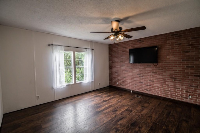 1530 Unity Church Cir, Maysville, GA 30558 - spare room with brick wall, hardwood / wood-style floors, a textured ceiling, and a ceiling fan