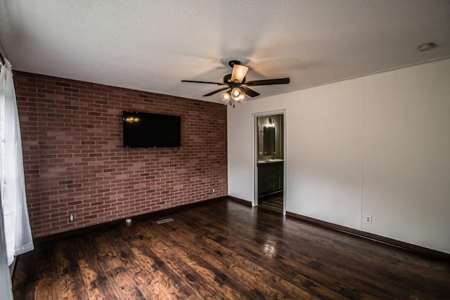 1530 Unity Church Cir, Maysville, GA 30558 - unfurnished living room with brick wall, a ceiling fan, wood finished floors, and a textured ceiling