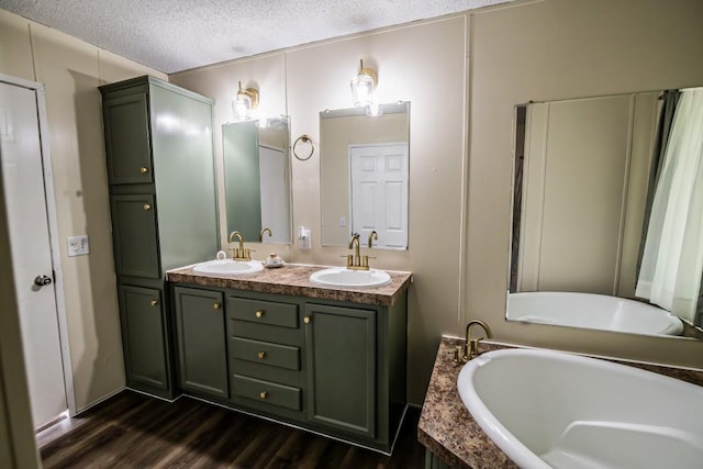 1530 Unity Church Cir, Maysville, GA 30558 - full bathroom featuring double vanity, a bath, wood finished floors, and a textured ceiling