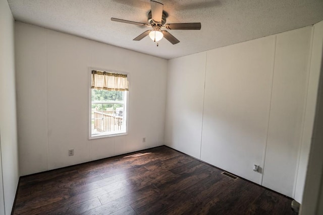1530 Unity Church Cir, Maysville, GA 30558 - empty room with a ceiling fan, dark wood finished floors, and a textured ceiling