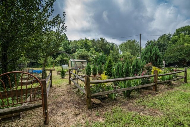 1530 Unity Church Cir, Maysville, GA 30558 - gate featuring an exterior structure, an outbuilding, and a garden