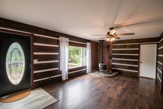 1530 Unity Church Cir, Maysville, GA 30558 - foyer entrance featuring a wood stove, wooden walls, wood finished floors, and a ceiling fan