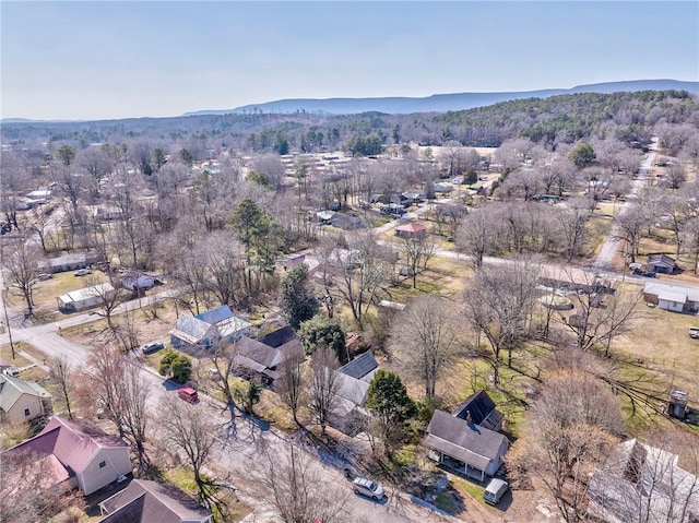 birds eye view of property with a view of trees and a mountain view