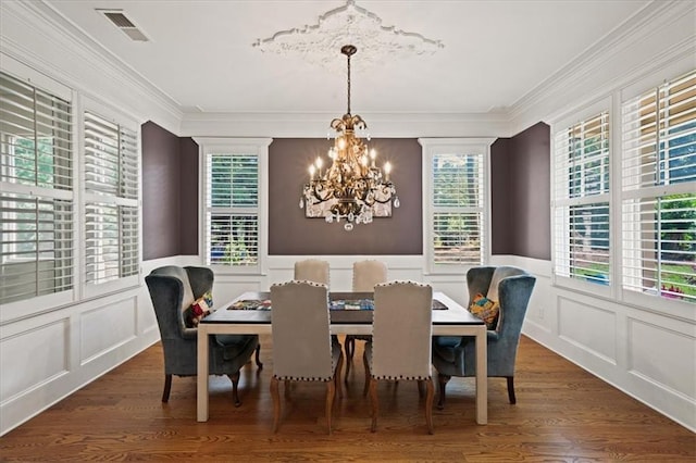 1323 Frey Lake Ct, Kennesaw, GA 30144 - dining space with a chandelier, a decorative wall, wood finished floors, crown molding, and wainscoting