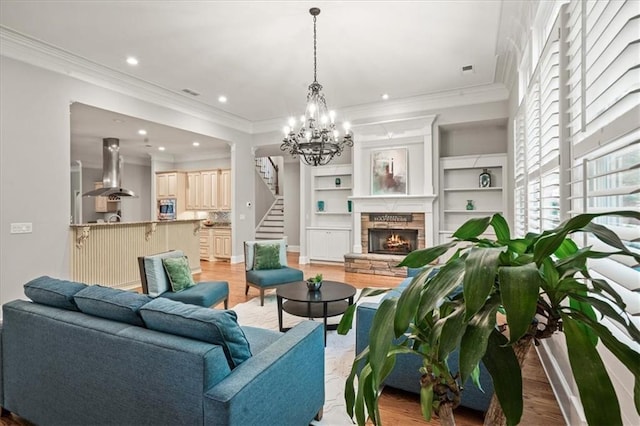 1323 Frey Lake Ct, Kennesaw, GA 30144 - living area featuring light wood-type flooring, stairs, a chandelier, recessed lighting, and a stone fireplace