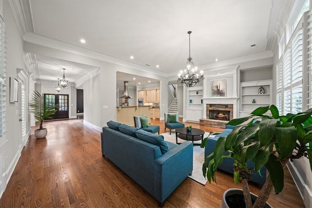1323 Frey Lake Ct, Kennesaw, GA 30144 - living area with a chandelier, a fireplace, stairway, wood finished floors, and crown molding