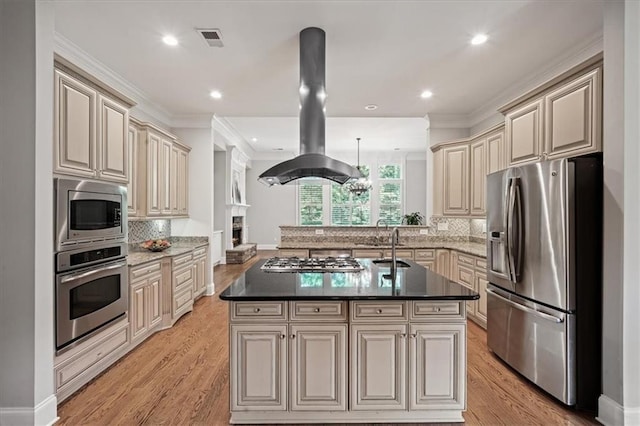 1323 Frey Lake Ct, Kennesaw, GA 30144 - kitchen with appliances with stainless steel finishes, cream cabinets, island range hood, a peninsula, and tasteful backsplash
