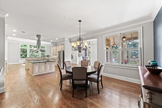1323 Frey Lake Ct, Kennesaw, GA 30144 - dining area featuring ornamental molding, a chandelier, baseboards, light wood-style floors, and recessed lighting