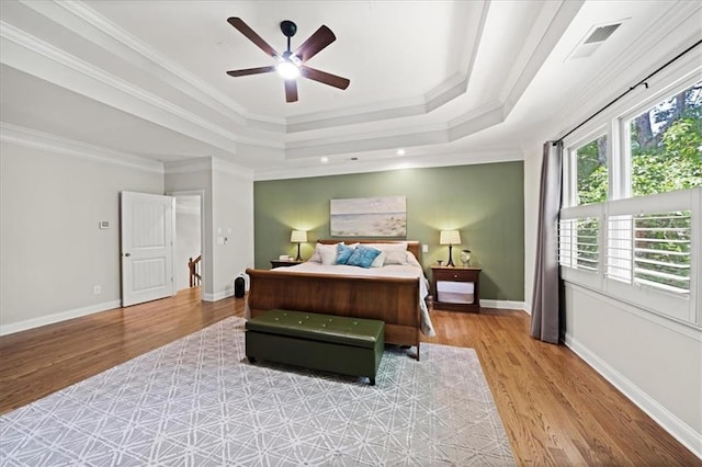 1323 Frey Lake Ct, Kennesaw, GA 30144 - bedroom featuring light wood finished floors, a tray ceiling, ornamental molding, and baseboards