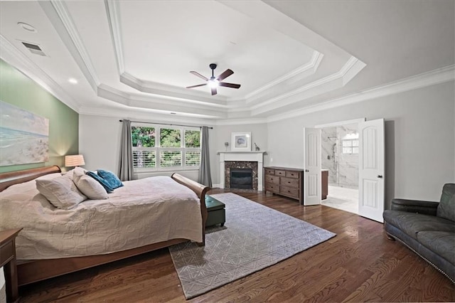 1323 Frey Lake Ct, Kennesaw, GA 30144 - bedroom featuring crown molding, a tray ceiling, wood finished floors, a fireplace, and ensuite bath