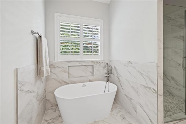 1323 Frey Lake Ct, Kennesaw, GA 30144 - bathroom featuring marble tiled floors, tile walls, a marble finish shower, a freestanding bath, and wainscoting