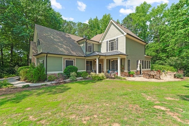1323 Frey Lake Ct, Kennesaw, GA 30144 - view of front of house featuring a fire pit, a standing seam roof, a front lawn, and covered porch