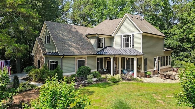 1323 Frey Lake Ct, Kennesaw, GA 30144 - view of front of home featuring a standing seam roof, a front yard, metal roof, covered porch, and roof with shingles