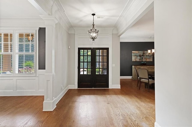 1323 Frey Lake Ct, Kennesaw, GA 30144 - foyer entrance featuring french doors, a chandelier, wood finished floors, ornate columns, and ornamental molding