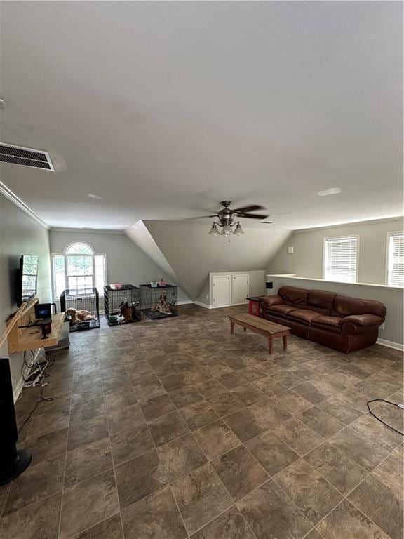 additional living space featuring ceiling fan and lofted ceiling