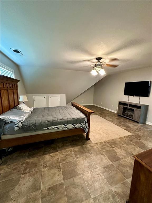 bedroom featuring ceiling fan and lofted ceiling