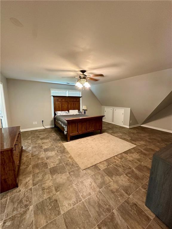 bedroom with ceiling fan and vaulted ceiling