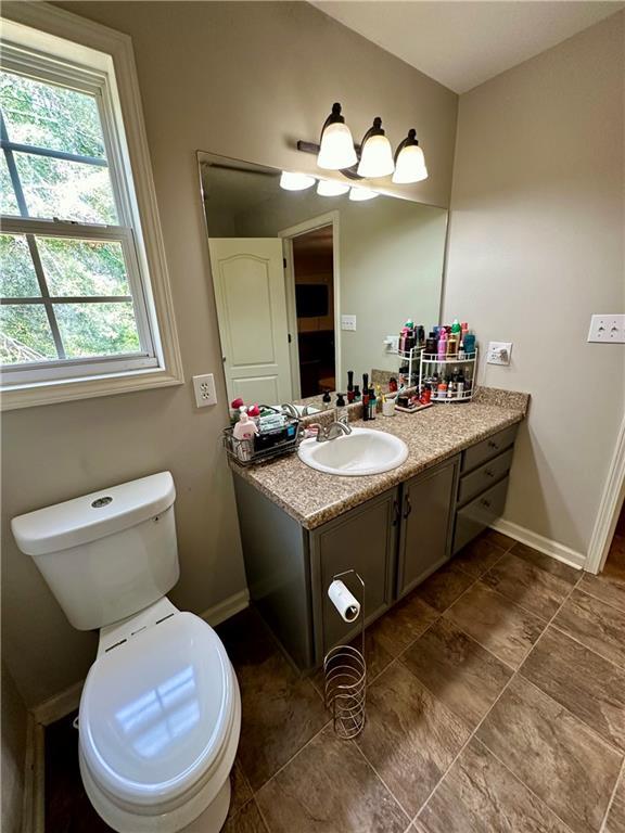 bathroom featuring vanity and toilet