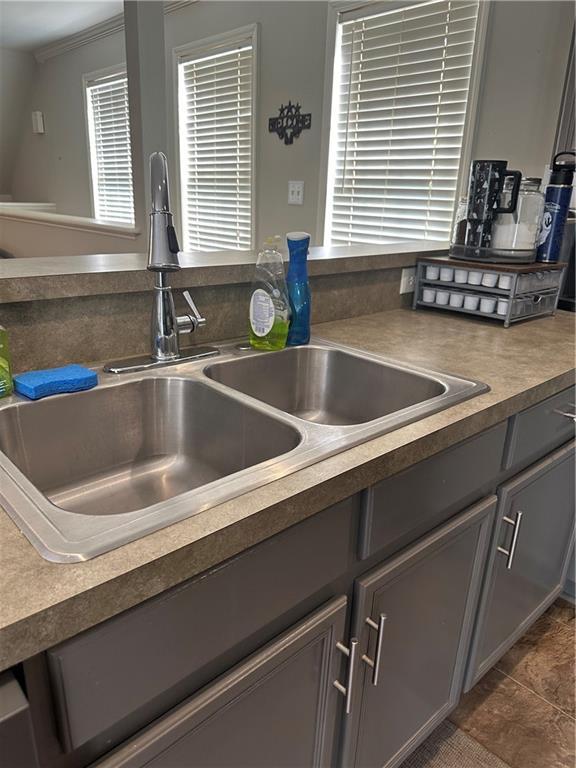 kitchen with sink and ornamental molding