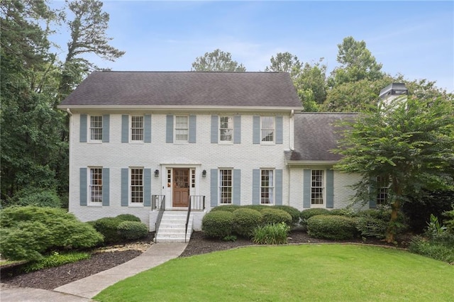 1054 Foreststone Way SW, Marietta, GA 30064 - colonial inspired home with a front lawn, brick siding, a chimney, and roof with shingles