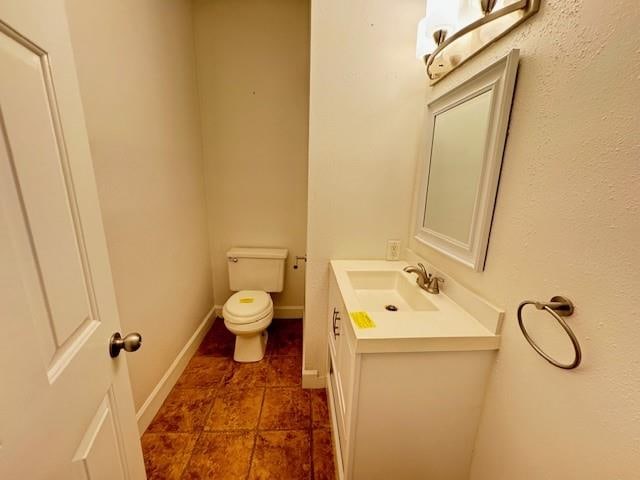 bathroom featuring toilet, vanity, and tile patterned floors