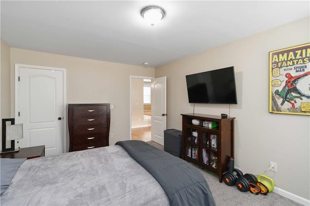 bedroom with baseboards and carpet flooring