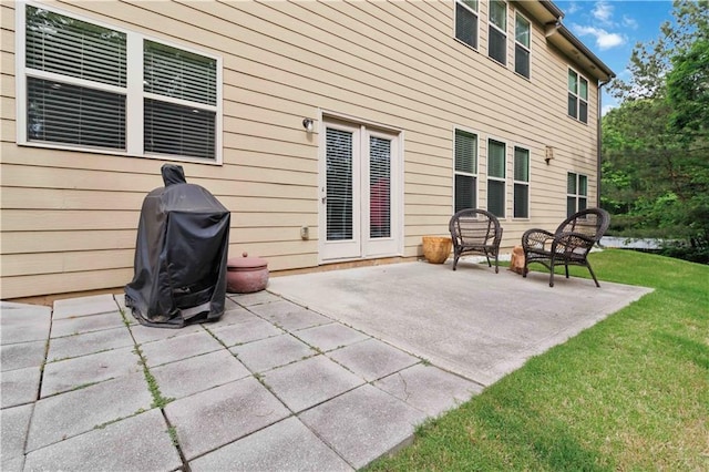 rear view of house featuring a patio and a lawn