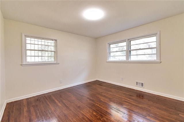 unfurnished room with dark hardwood / wood-style floors