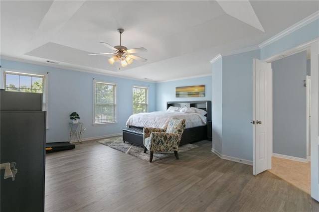 829 Castlebottom Dr, Lawrenceville, GA 30045 - bedroom featuring a tray ceiling, wood finished floors, baseboards, crown molding, and a ceiling fan