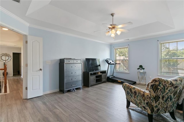 829 Castlebottom Dr, Lawrenceville, GA 30045 - sitting room with a raised ceiling, light wood finished floors, ceiling fan, baseboards, and crown molding