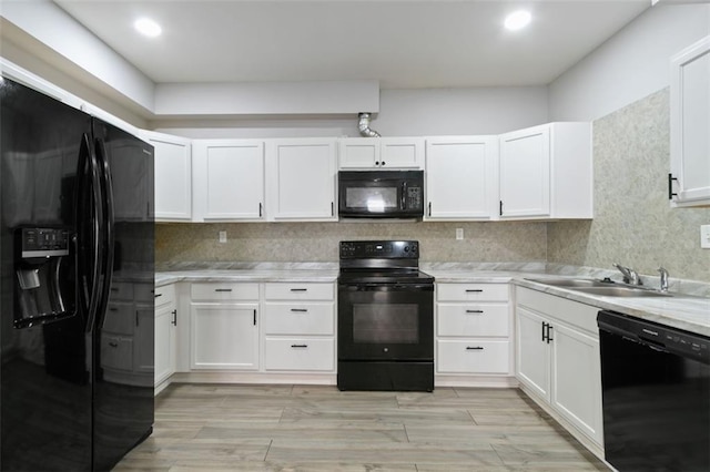 829 Castlebottom Dr, Lawrenceville, GA 30045 - kitchen with black appliances, a sink, light countertops, and white cabinets