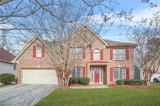 colonial inspired home featuring a garage and a front lawn