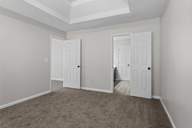 unfurnished bedroom with carpet flooring and a textured ceiling