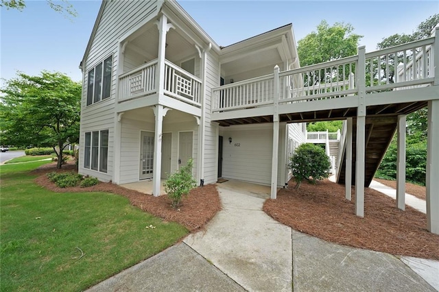 602 Abingdon Way, Atlanta, GA 30328 - view of front of house with a garage, concrete driveway, stairway, and a balcony