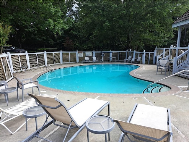 602 Abingdon Way, Atlanta, GA 30328 - view of swimming pool with a patio and view of wooded area