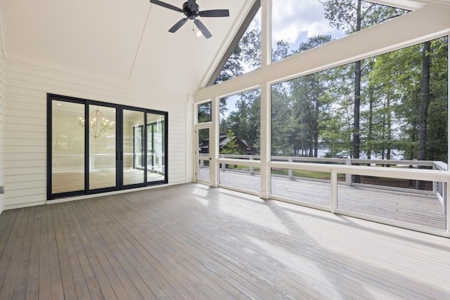 unfurnished sunroom featuring vaulted ceiling and a ceiling fan