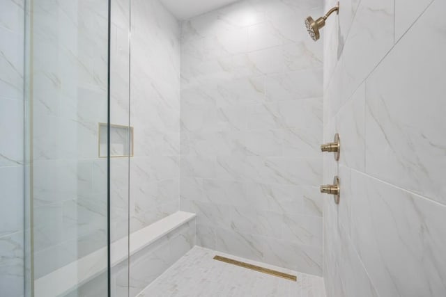 full bath with a tile shower