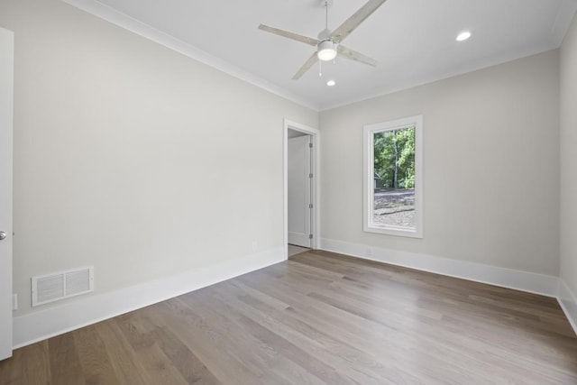 empty room featuring recessed lighting, visible vents, baseboards, light wood-type flooring, and crown molding