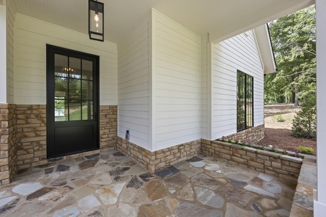 property entrance with stone siding