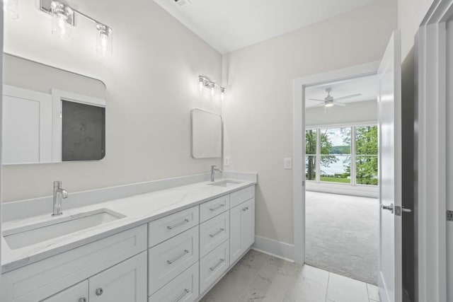 bathroom featuring double vanity, baseboards, and a sink