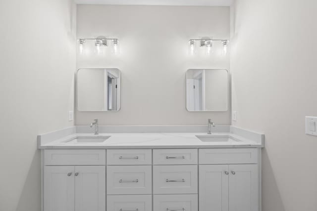 full bathroom featuring double vanity and a sink