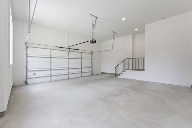 garage featuring recessed lighting, baseboards, and a garage door opener