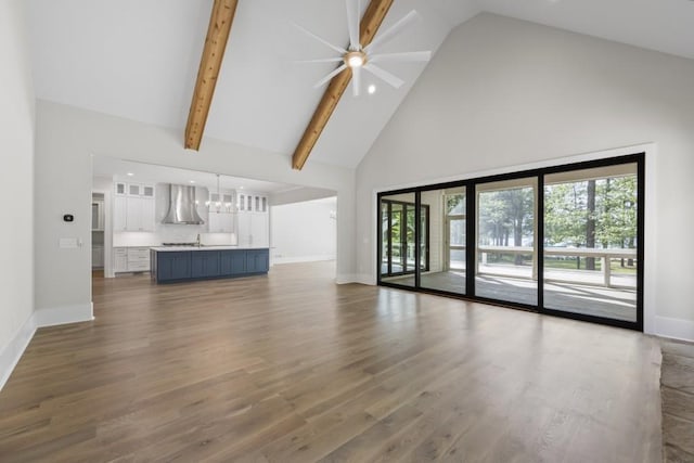 unfurnished living room with baseboards, dark wood-type flooring, and a healthy amount of sunlight