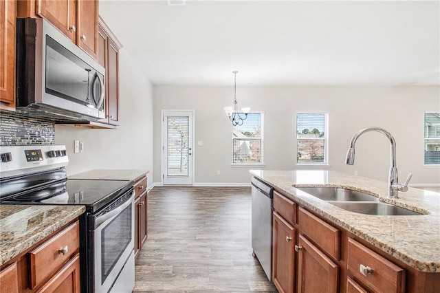 kitchen featuring brown cabinets, appliances with stainless steel finishes, and a sink