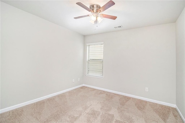 unfurnished room with visible vents, a ceiling fan, baseboards, and carpet floors