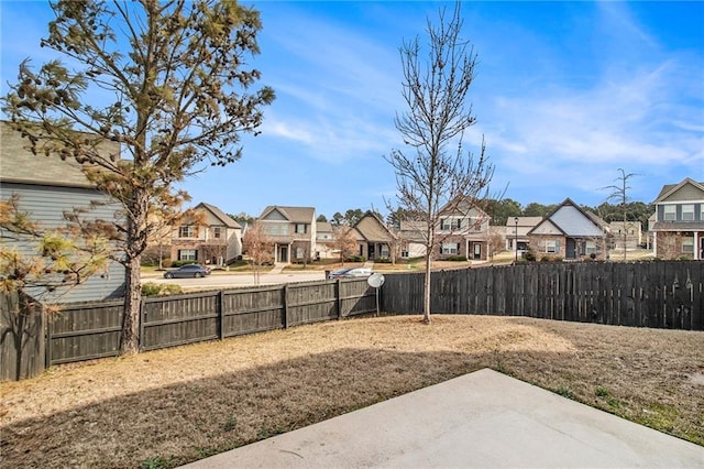 view of yard with a patio area, a residential view, and fence