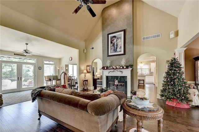 living room featuring french doors, high vaulted ceiling, ceiling fan, and dark wood-type flooring